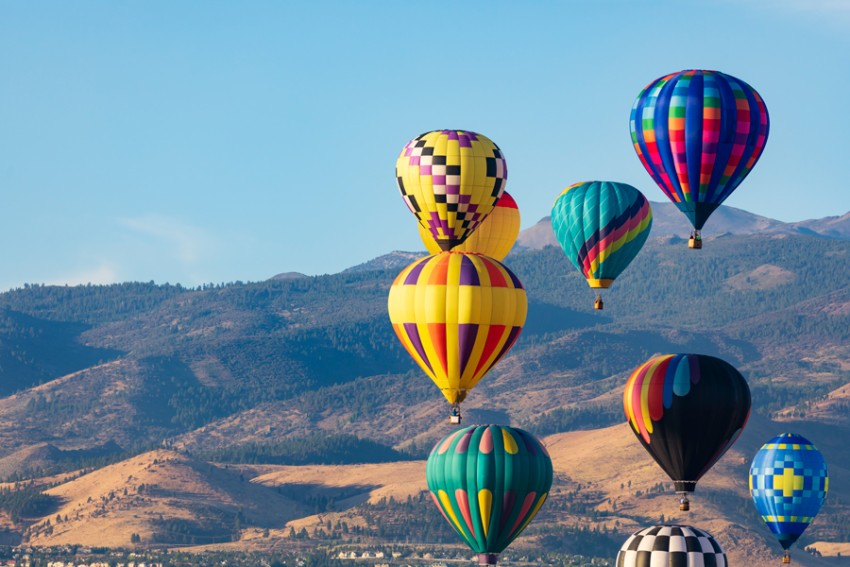 Hot air balloons over mountains