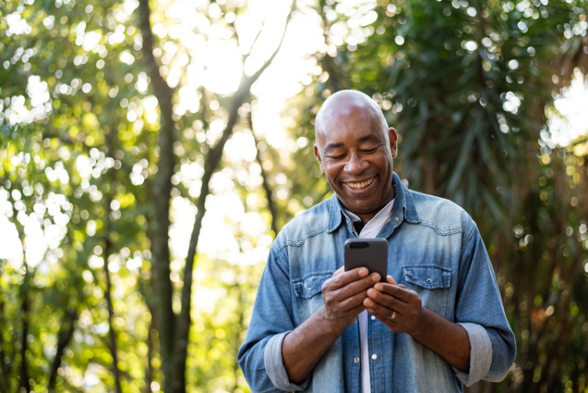 older man looking at mobile phone